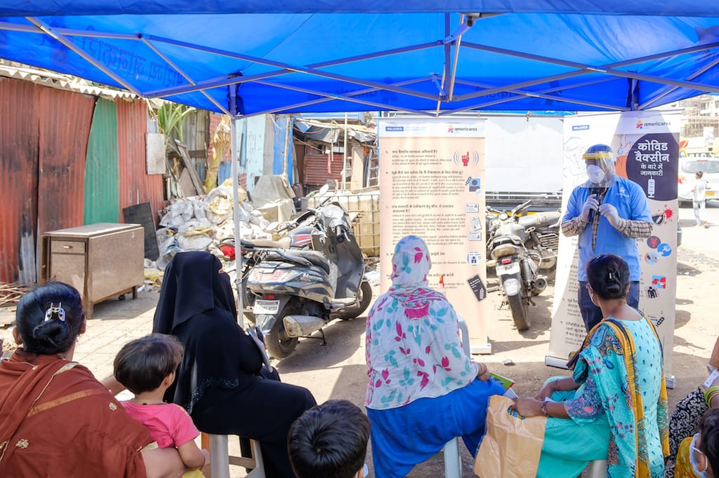 An Americares India mobile health clinic staff member provides care and information regarding COVID-19 for residents with little or no health care access.