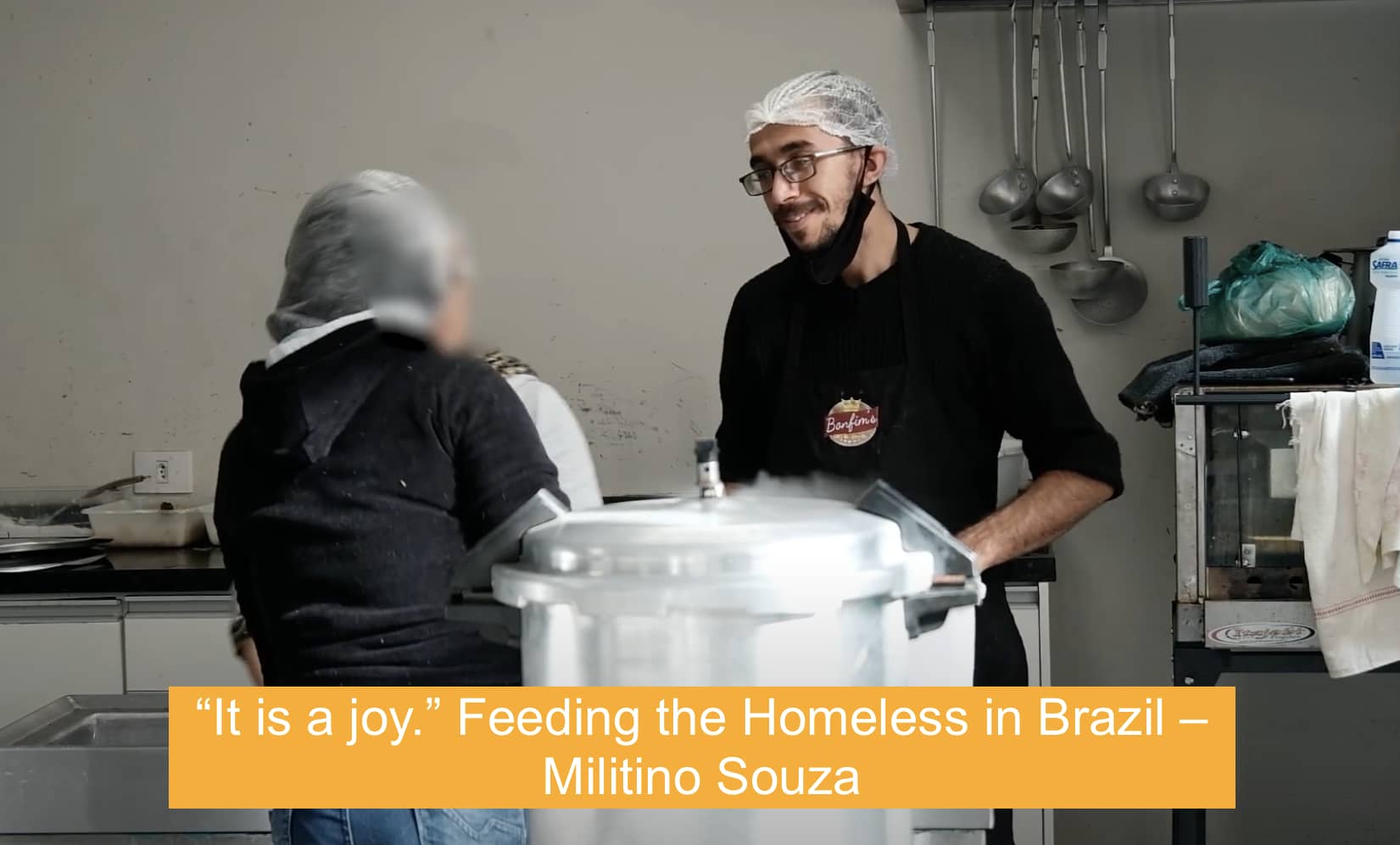 Photo of smiling volunteer in new kitchen that feeds the homeless in Brazil and was built with a grant from The Prem Rawat Foundation