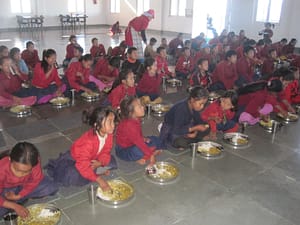 Children eating while watching educational TV at FFP facility