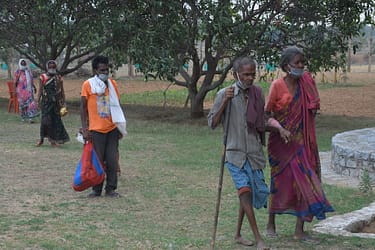 Disabled people pick up bags of food at the Food for People facility in India