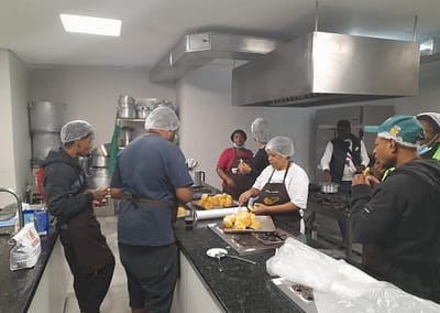 Photo of people learning to cook in the new kitchen in Brazil that was built with a grant from The Prem Rawat Foundation