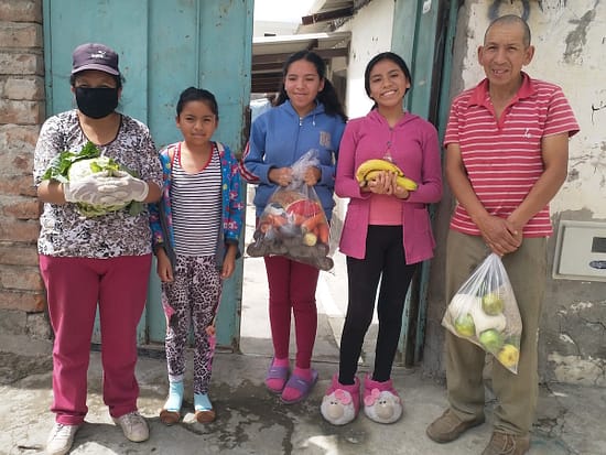 A family enjoys their food delivery from the Seeds of Hope project