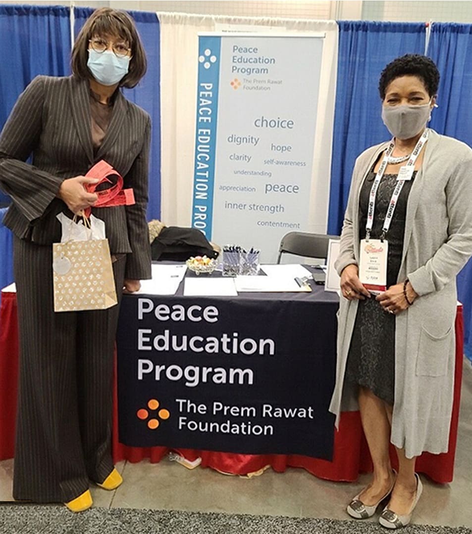 APPA Communications Executive Director Veronica Cunningham (left) with Leonie Small, at the Peace Education Program booth