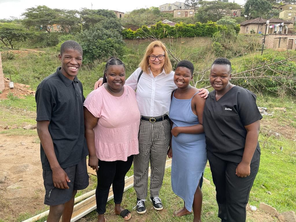 Peace Education Program Director Willow Baker meets with members of the Likhon iThemba team.