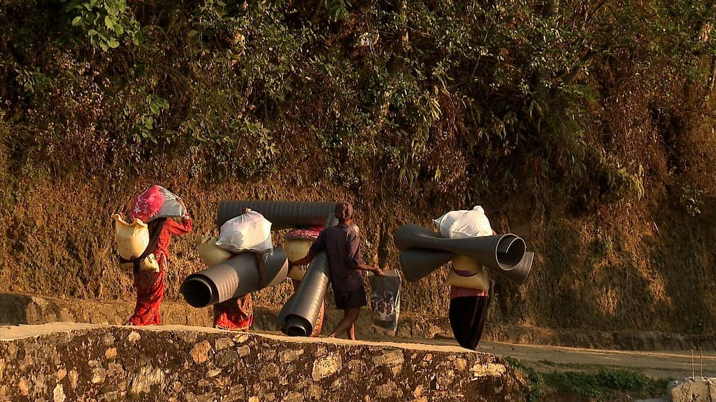 Residents carry their supplies back to their homes