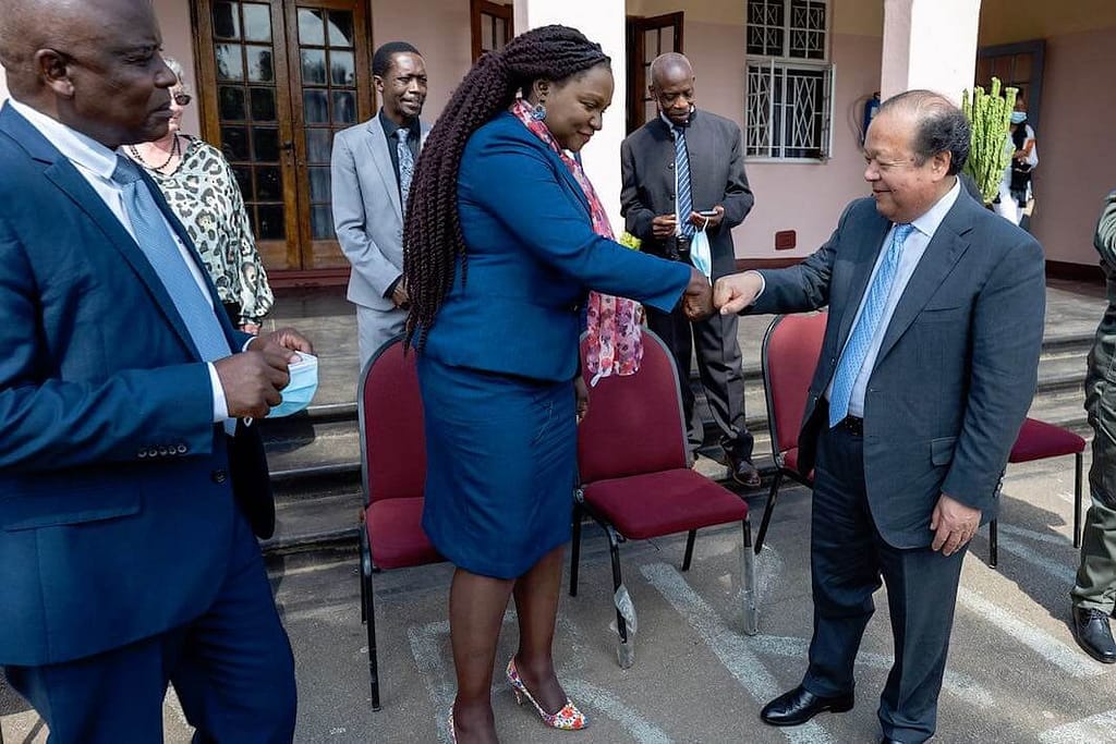 Prem Rawat fist bumps officials at a Zimbabwe prison
