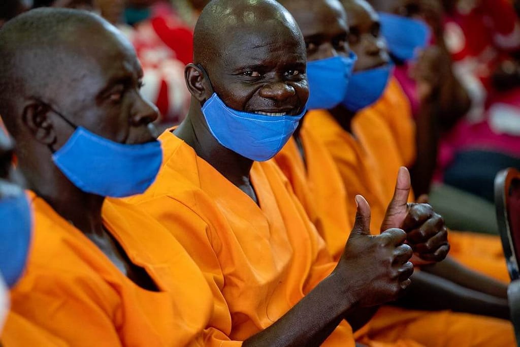 A Peace Education Program participant at a Zimbabwe prison gives two thumbs up for what Prem Rawat says during a live event