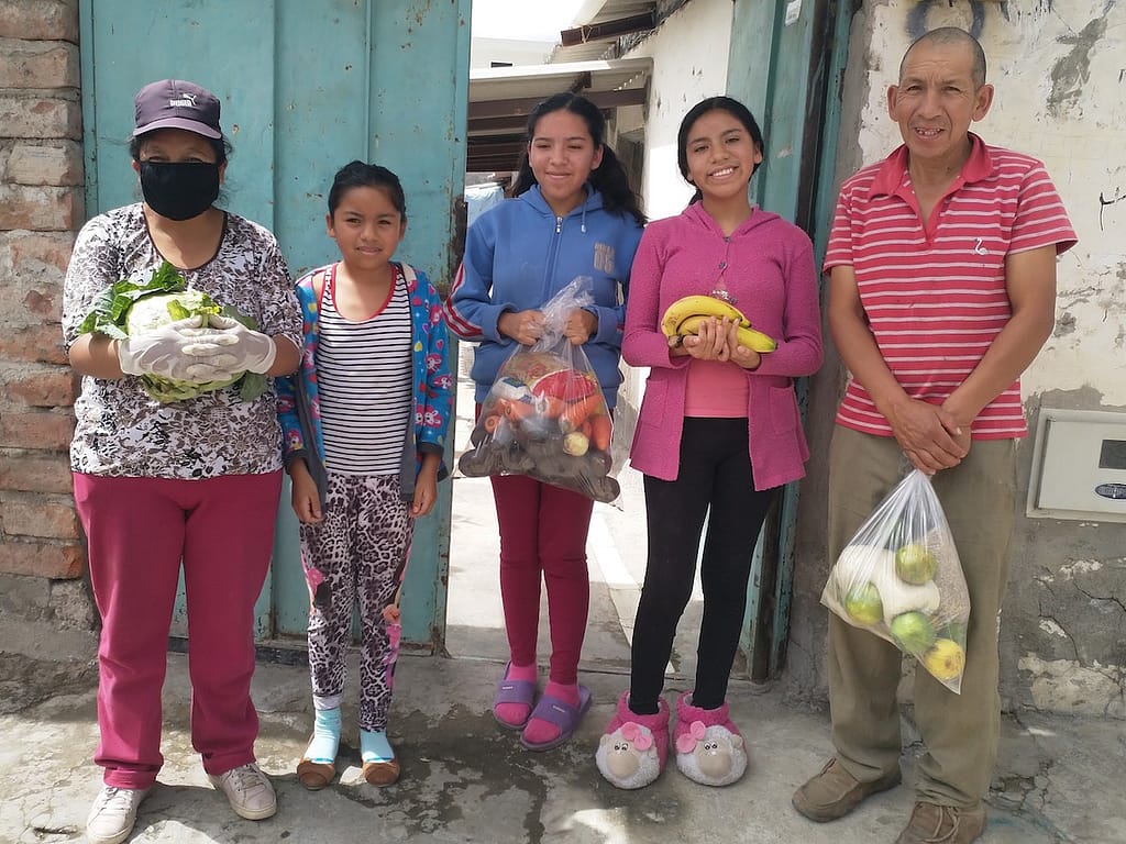 A family enjoys their food delivery from the Seeds of Hope project